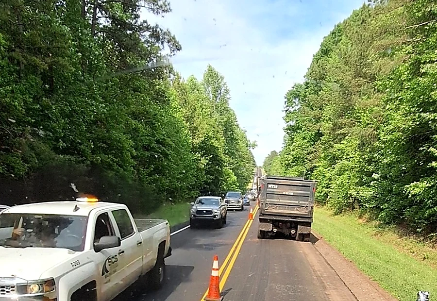 Trucks operating through a coned-off roadwork area