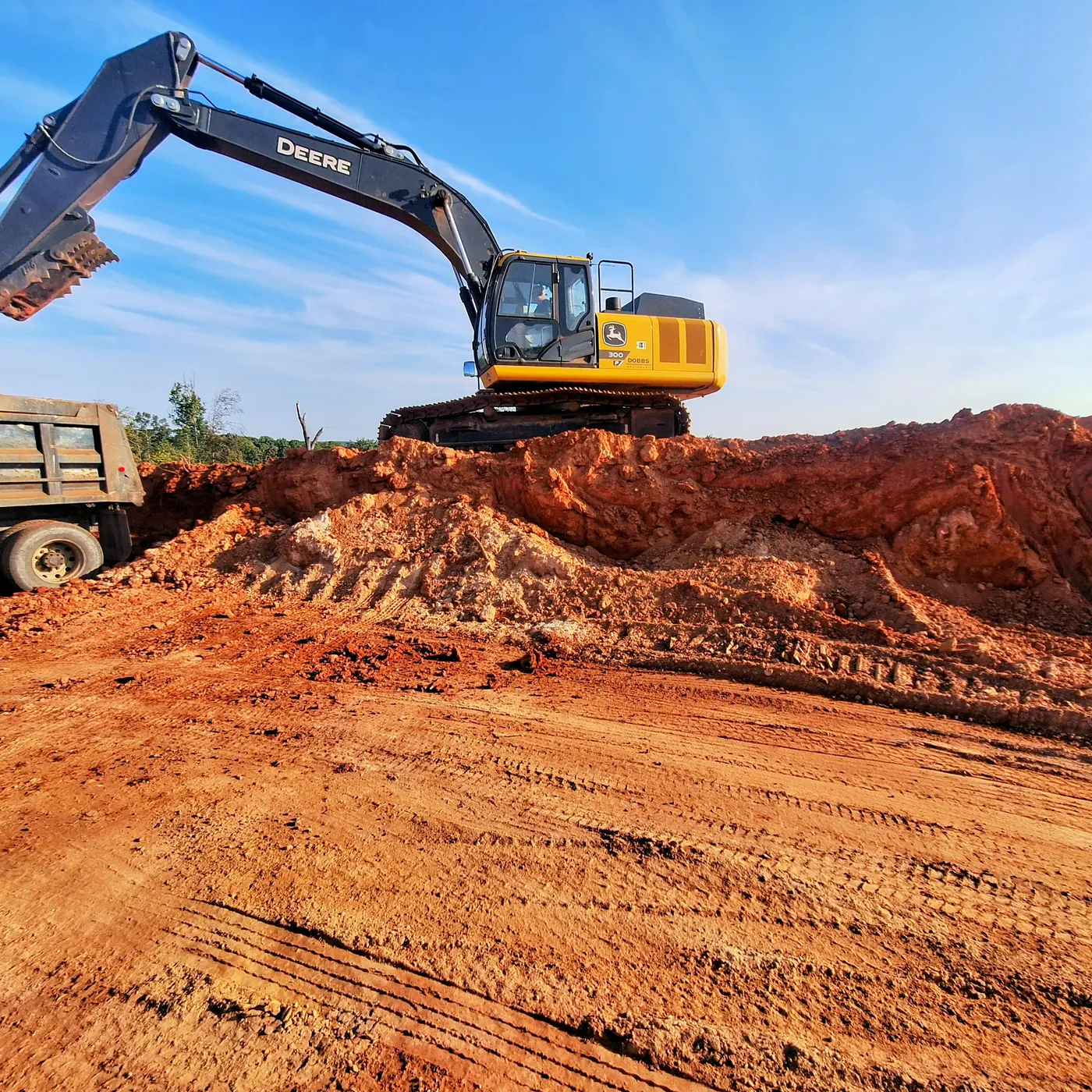 Excavator working above an active earthmoving site