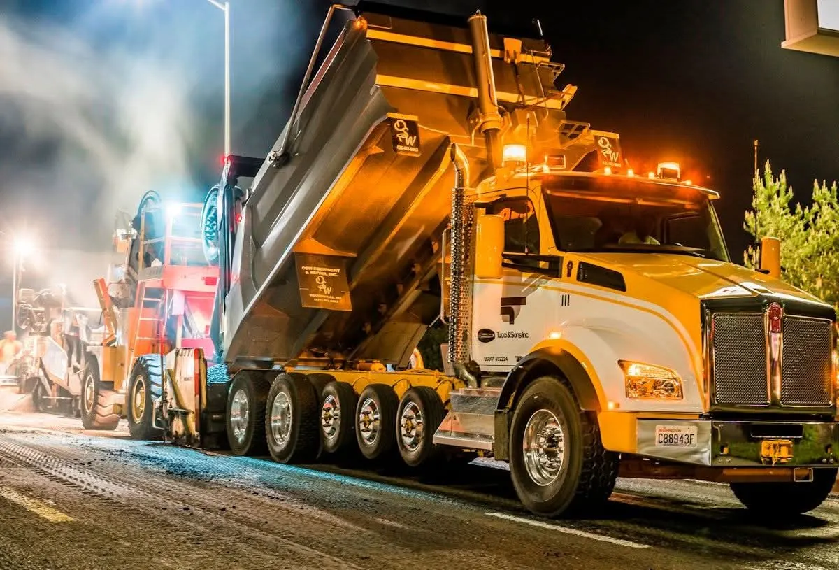 Dump truck supporting a night paving operation
